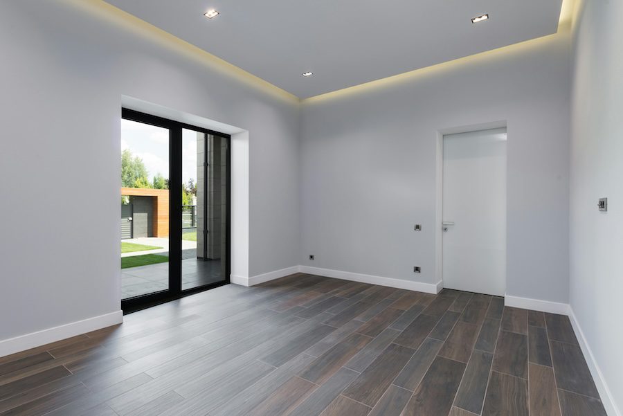 pexels-heyho-7031619 An interior photo showing a living room or kitchen with evenly spaced recessed LED lights in the ceiling.