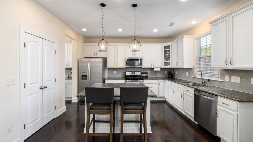 Sleek modern kitchen interior featuring recessed lighting for a room-by-room guide