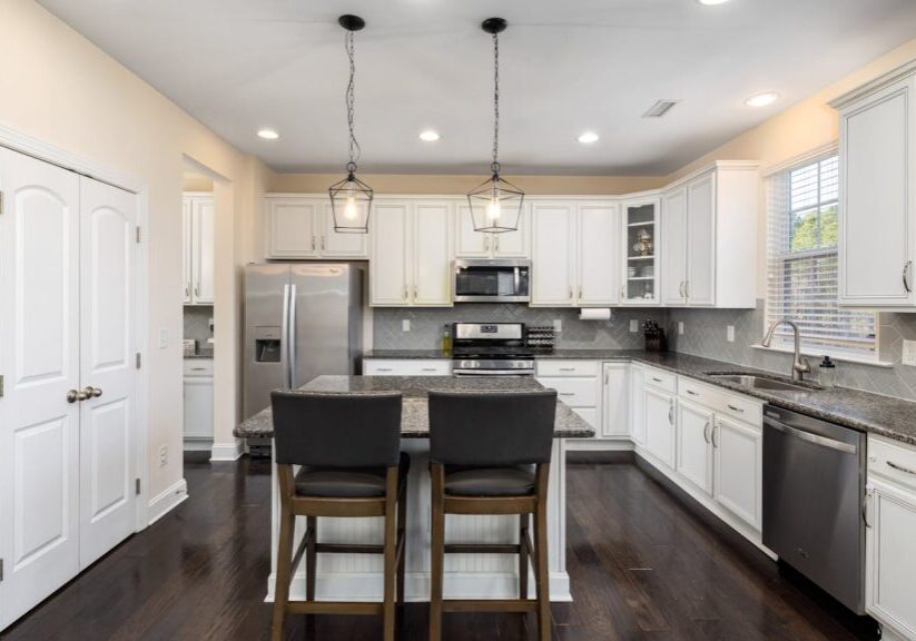 Sleek modern kitchen interior featuring recessed lighting for a room-by-room guide